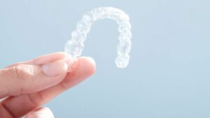 Person Holding A Clear Plastic Retainer