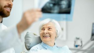 A Senior Citizen Smiling At A Dentist