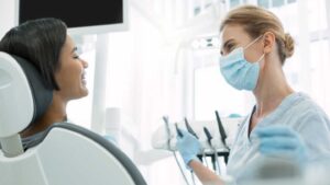 Dentist Consulting With A Patient During Root Canal